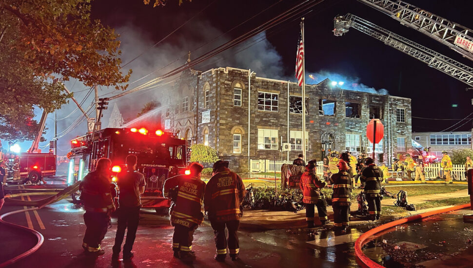 Firefighters gather outside St. Francis of Assisi School Oct. 7.
