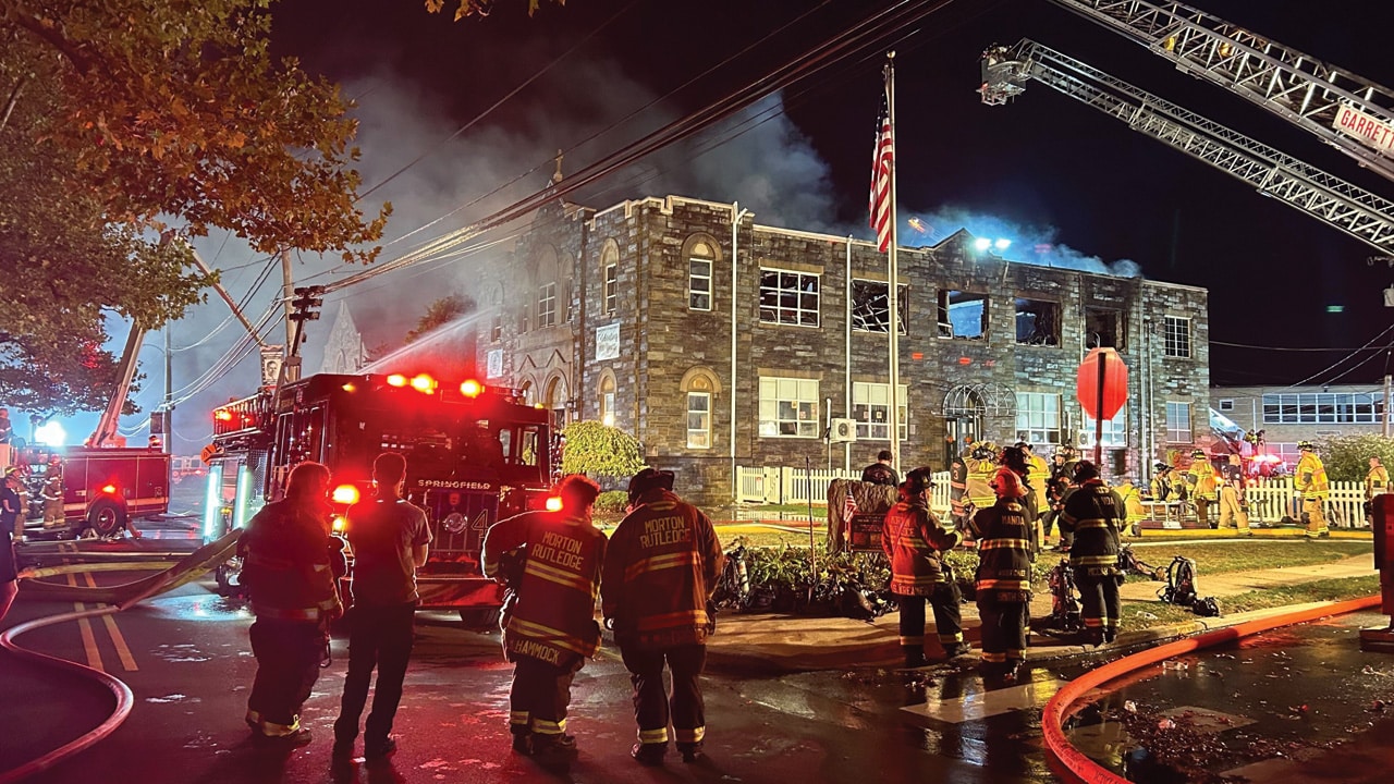 Firefighters gather outside St. Francis of Assisi School Oct. 7.