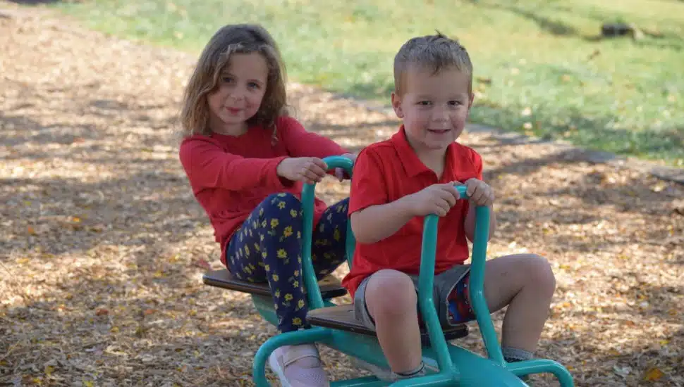 A boy and girl enjoy new playground equipment at Whitemarsh's Miles Park in Lafayette Hill.