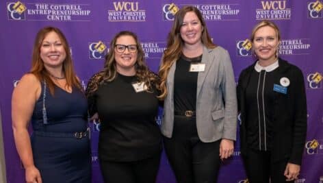 Four women in business attire at the Cottrell Entrepreneurship Center at West Chester University.