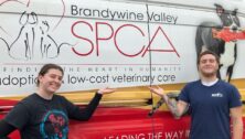 2 Brandywine Valley SPCA staffers in front of the SPCA van.