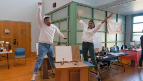 The founders of ChompShop, Kausi Raman and Max Liechty excitedly jump into the air.