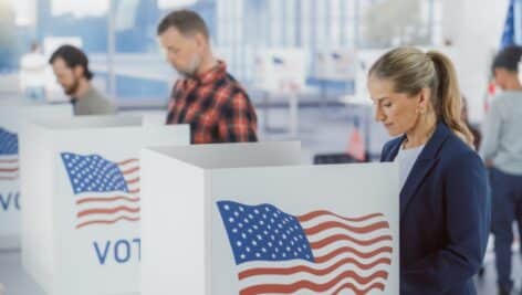 Voters fill out ballots at a polling location.