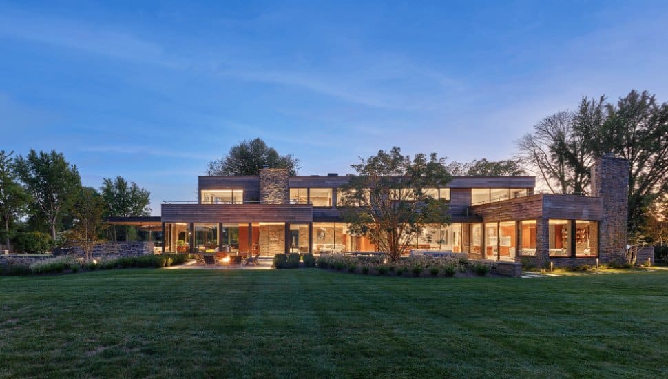 A nighttime view of the exterior of the restored Birch Knoll home.