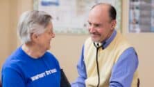 A doctor talks with a Dunwoody Village resident wearing a "Dunwoody Strong" shirt.