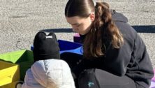 Amelia Fletcher spends time outdoors with a child from Kensington.