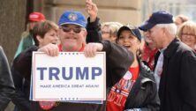 A supporter holds up a Trump sign.