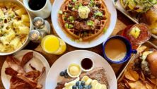 A table loaded with breakfast, lunch and dinner foods.