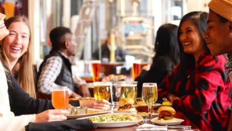 Customers enjoying a meal inside an Iron Hill Brewery.