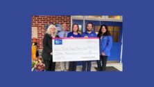 First Resource Bank team members presenting a check to a local school.