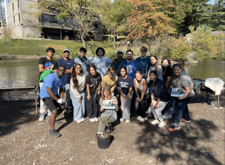 Students at Penn State Abington (gathered in group) who participated in planting trees on campus.