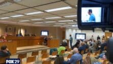 An overview of the Delaware County Council meeting room with audience members below and councilmembers in the front.