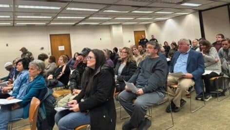 A packed county council meeting room.