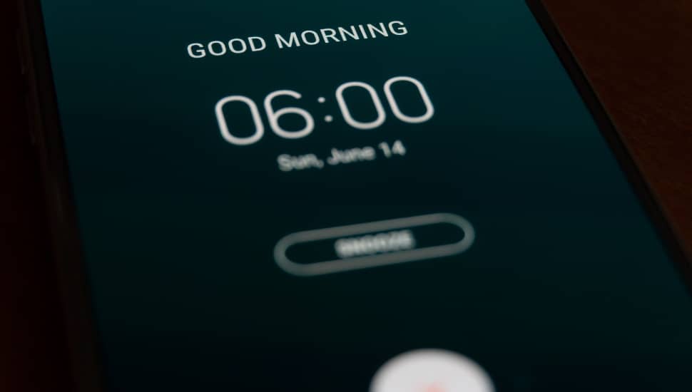 A smart phone alarm clock set for 6 AM.