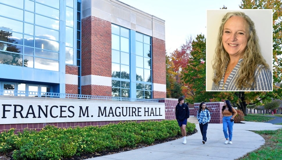 Nursing professor with students walking on a college campus.