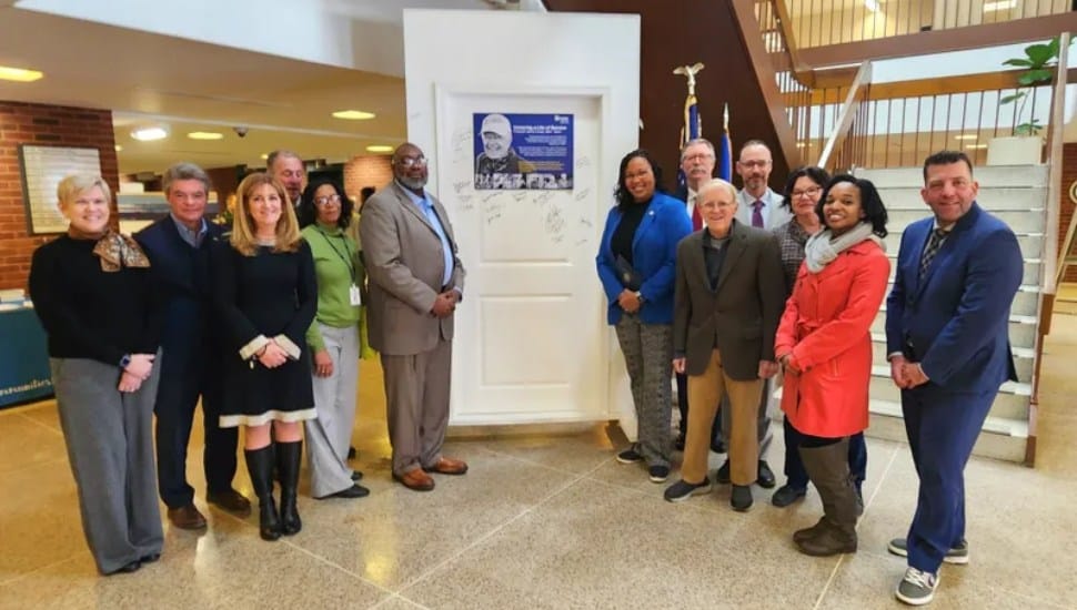 Delaware County officials gather at the door memorial for the late Jimmy Carter.