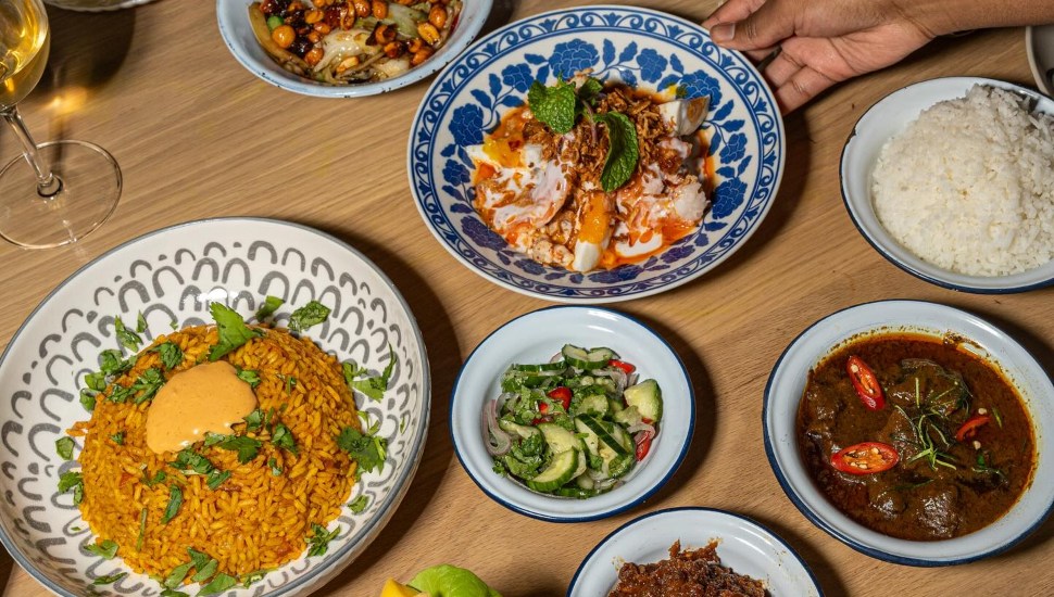 A table loaded with entrees and side dishes.