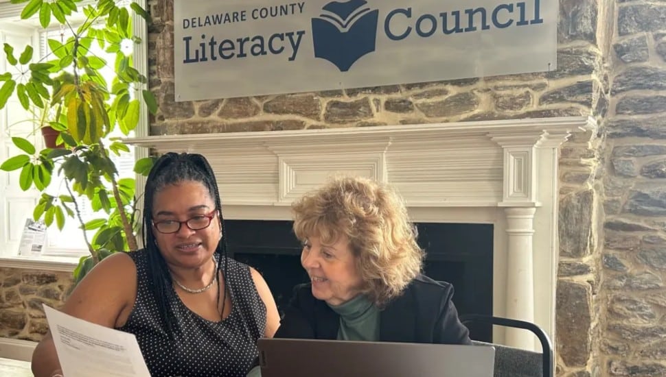 Two women working together in the Delaware County Literacy Council's main building.