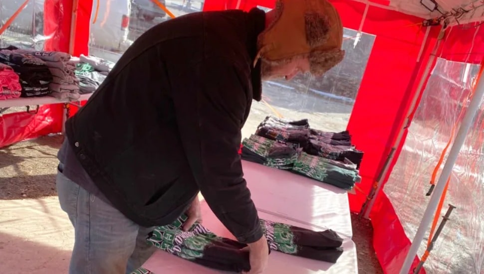 Chad Bowles from Florida sets up a temporary tent to sell Eagles merchandise in Delaware County.