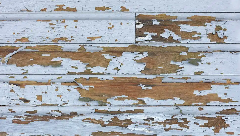 Peeling and cracked lead paint on wood siding.