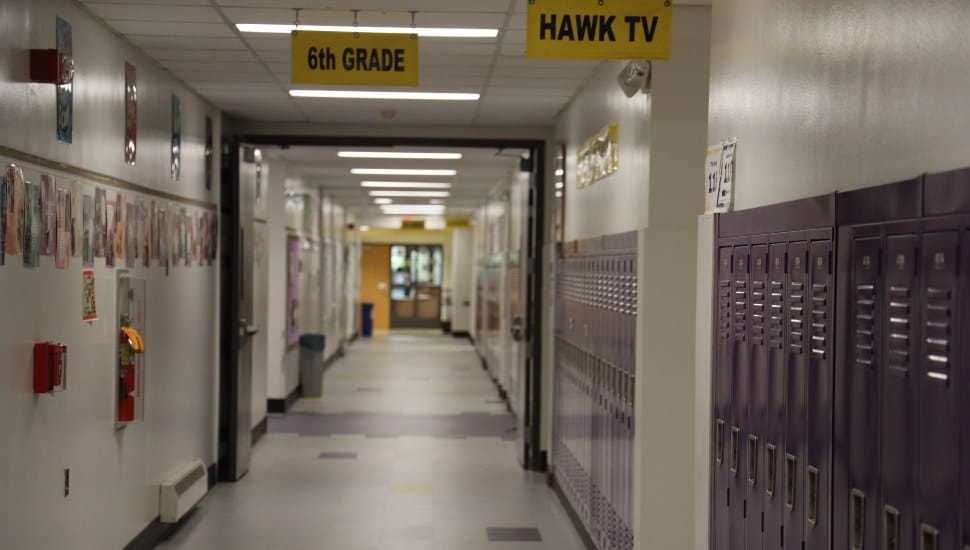 The locker-lined hallway of a school.