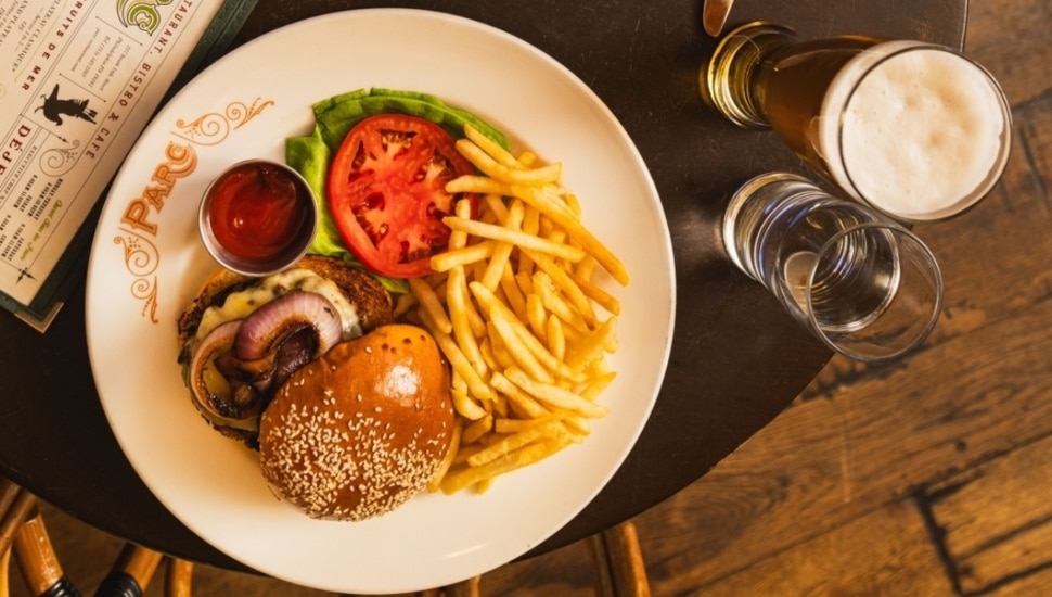 A burger and fries on a plate.