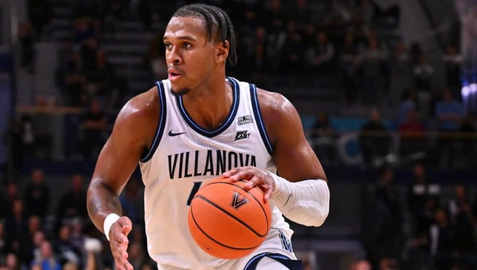 Eric Dixon with a basketball on the court.