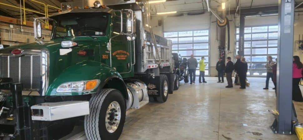 A public works truck parked in a large garage.
