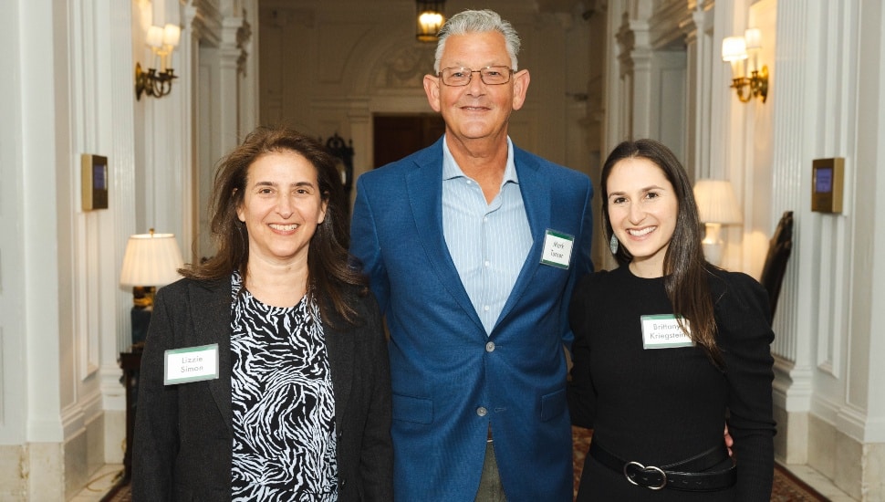Three co-authors pose for picture at a book launch.