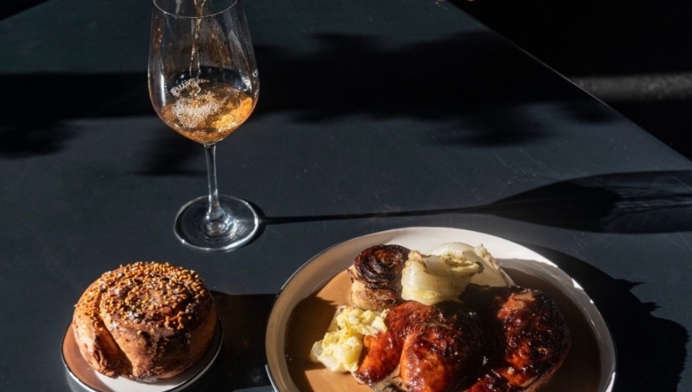 An entree, dessert and wine at a.kitchen restaruant.