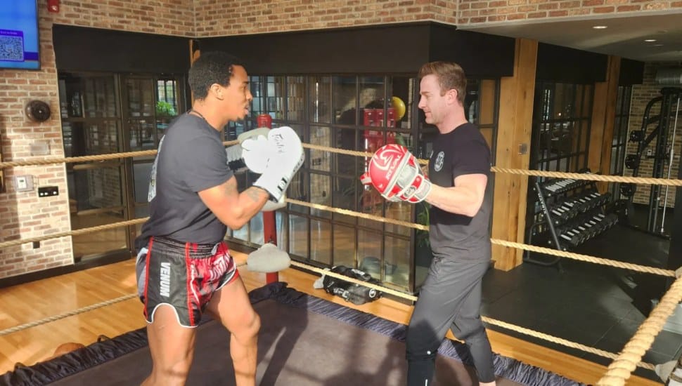Two men in a boxing ring that was used in Steve Spielberg's remake of West Side Story.