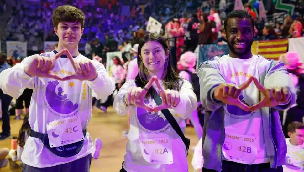 Penn State Brandywine students (from left) Joey Pretti, Julia D'Orazio and Philippe Latour show their diamonds before Penn State THON began on Friday night.