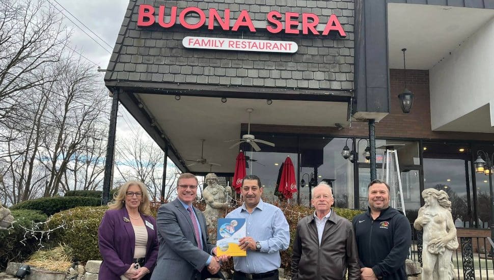 A group of men and women gather outside Buona Sera Horsham Ristorante.