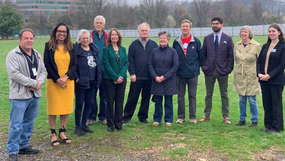 Local officials tour school's solar energy installation.