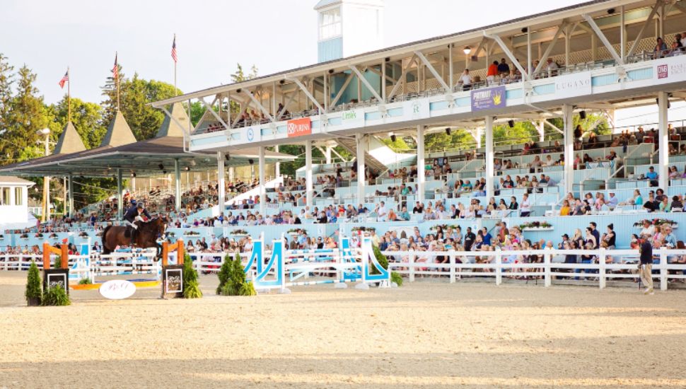 People in the stands on the Devon Horse Show grounds.