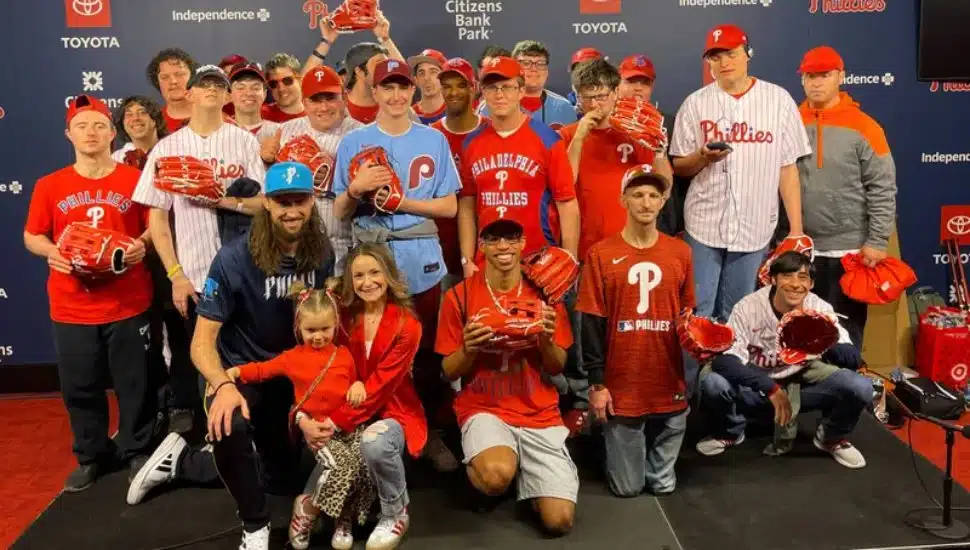 Newtown-Edgmont Angels posing with Phillies relief pitcher Matt Strahm, his wife and daughter.