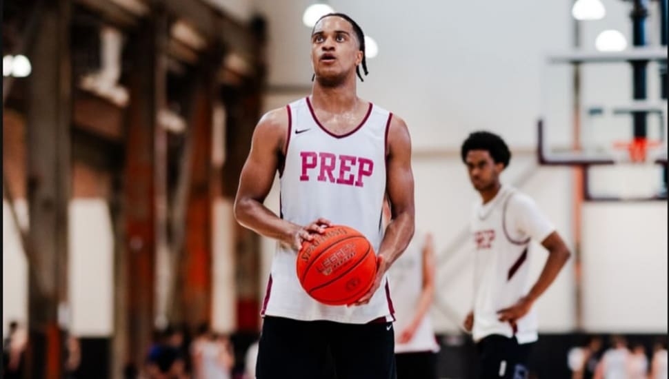 Olin Chamberlain Jr. holds a basketball on the court as he plans his next play.
