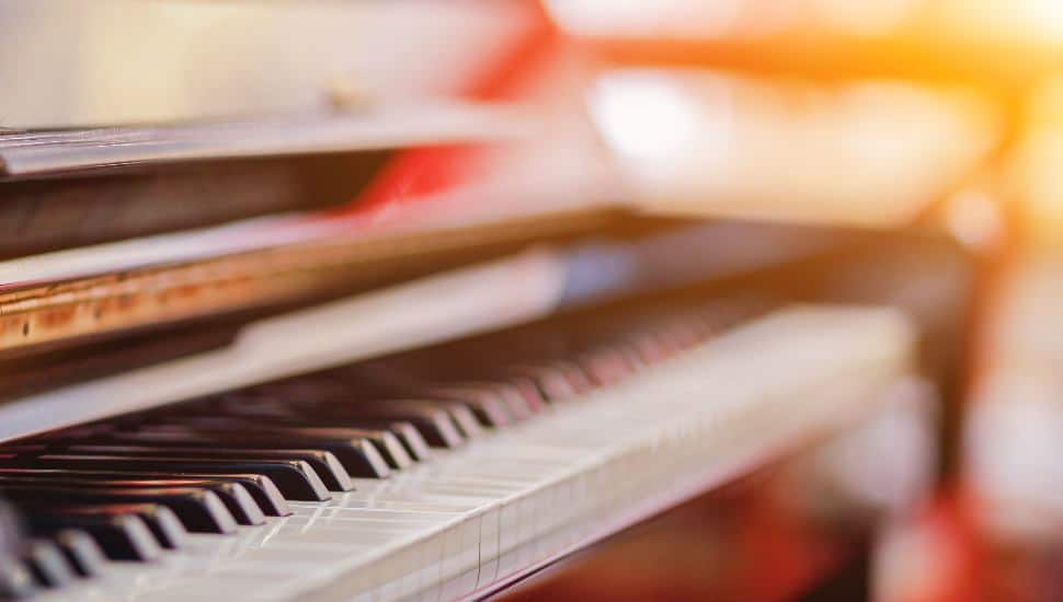 A slightly out-of-focus warmly-lit image of a piano keyboard.