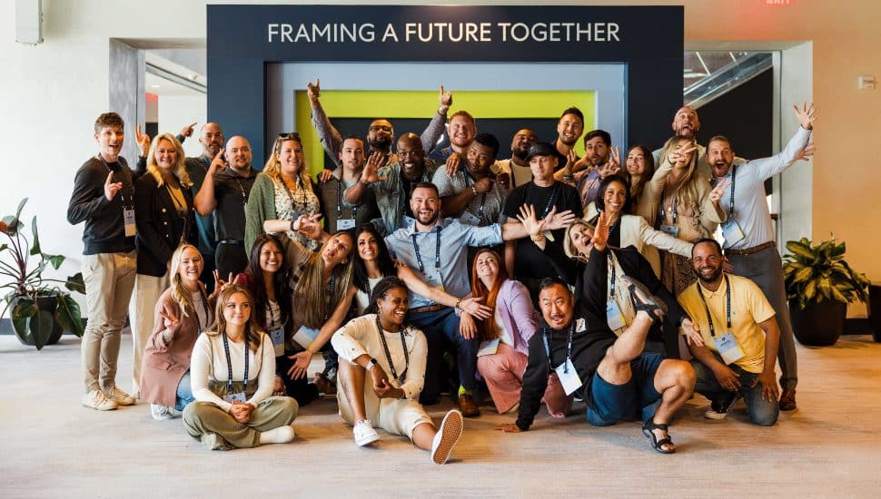 A large group of happy Power Home Remodeling employees gather for a photo opportunity at a company summit.