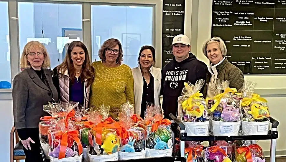 The staff and executives of Arc of Chester County and Partners in Outreach stand with a collection of Easter baskets.