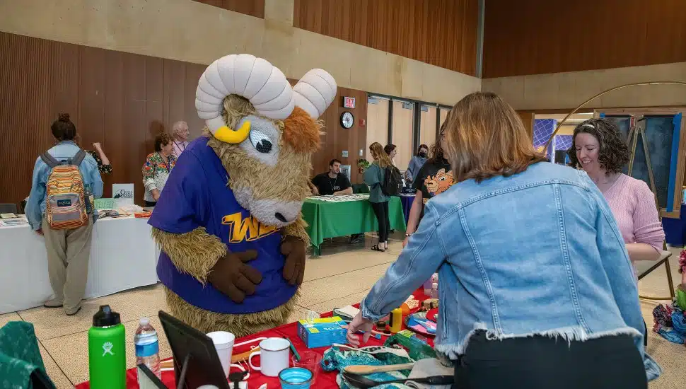 Rammy, the WCU mascot, gathers at a table at WCU’s Annual Zero Waste Summit.