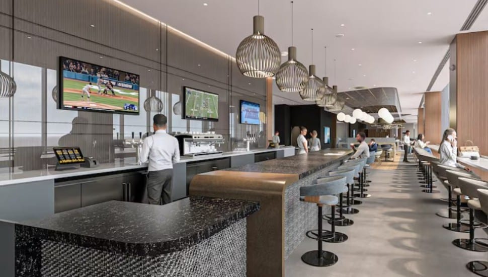 A counter and stools and tables, with a cook behind the counter, a rendering depicting the look of American Airline's new Flagship Lounge at the Philadelphia International Airport.