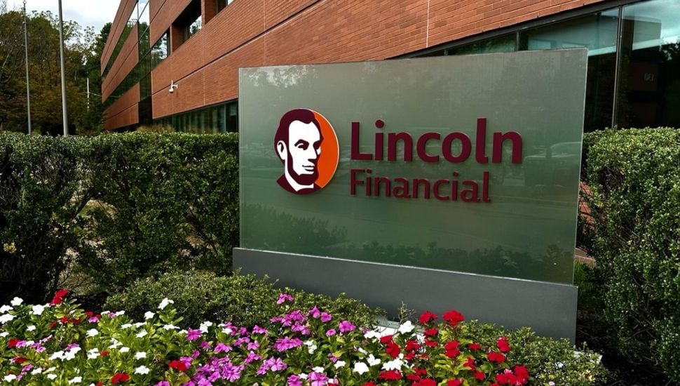 The new Lincoln Financial sign featuring an image of Abraham Lincoln outside the Radnor headquarters placed within a bed of blooming flowers.
