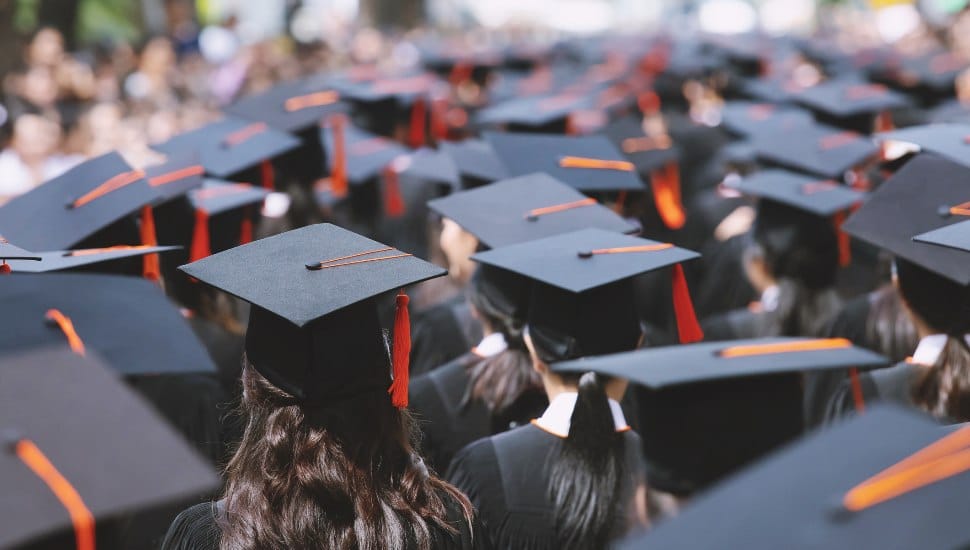 A group of graduating students with the graduation caps and tassels visible.