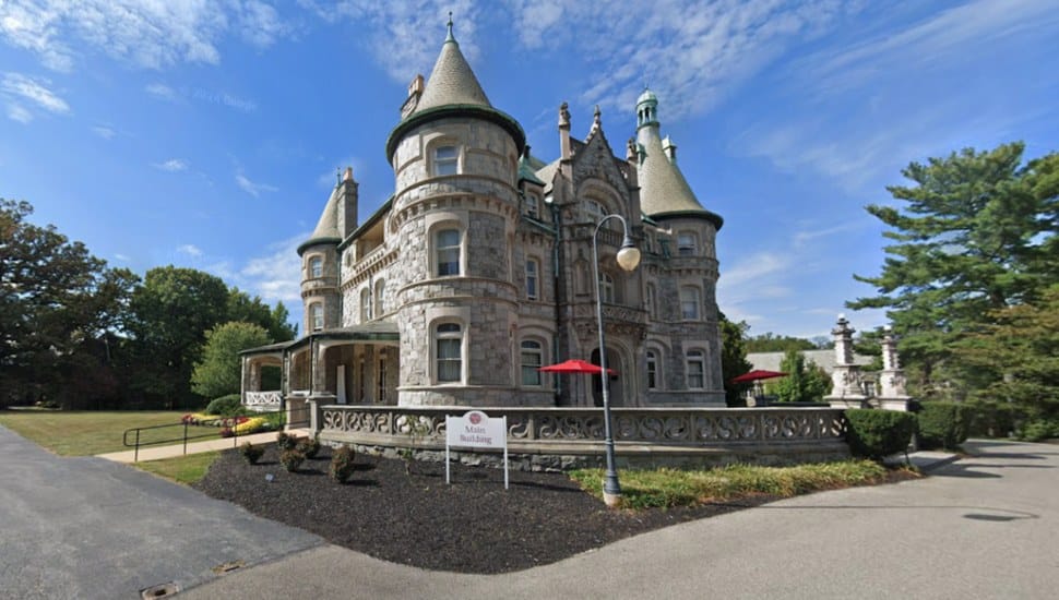 The main building for Rosemont College against a blue sky.