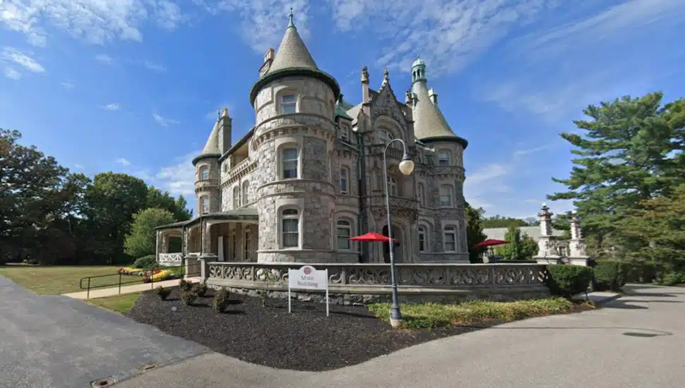 The main building for Rosemont College against a blue sky.