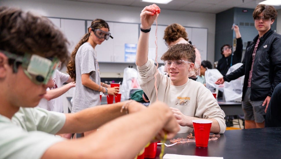 Ninth- and 10th-graders from Oxford Area High School design sensors and cup towers in a physics lab at West Chester University.