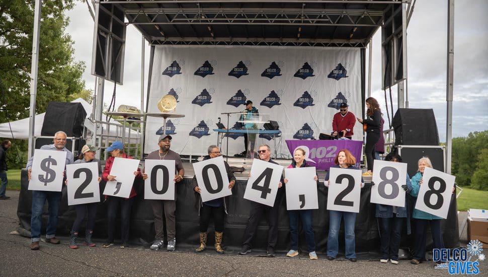 Supporters at a Delco Gives celebrate May 9 at Rose Tree Park hold up numbers denoting how much had been donated to the two-day campaign at that point.