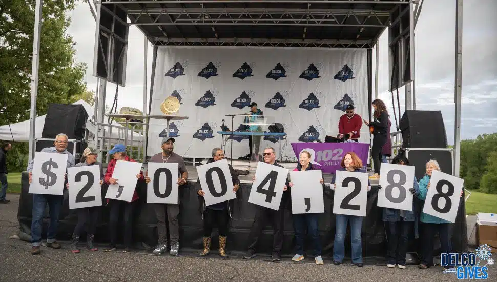 Supporters at a Delco Gives celebrate May 9 at Rose Tree Park hold up numbers denoting how much had been donated to the two-day campaign at that point.