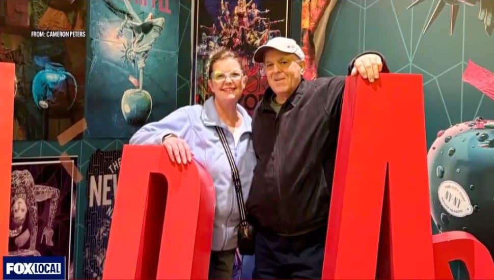 Cameron and Bill Peters smiling at a Las Vegas exhibit.